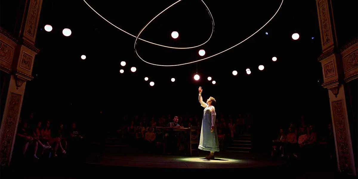 Isis Hainsworth as Thomasina Coverly beneath suspended lights in Arcadia