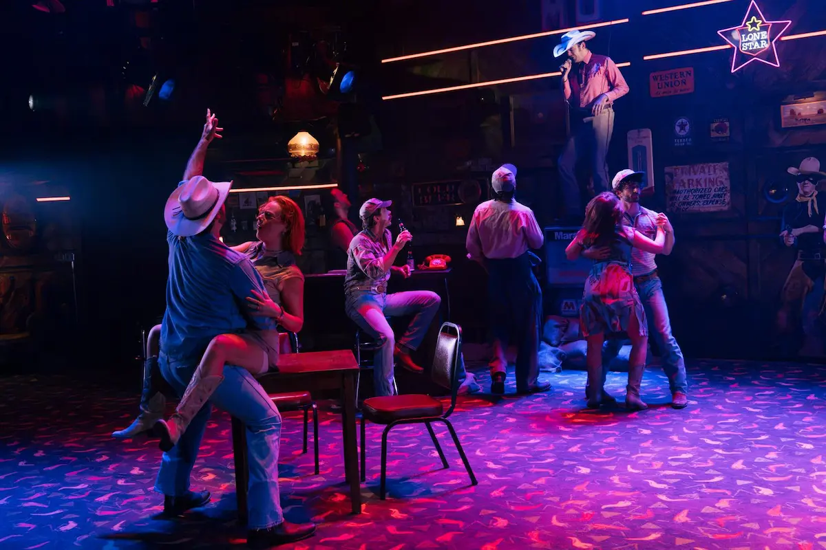 The company of Thelma & Louise the Musical in the bar scene at the Young Vic in 2026